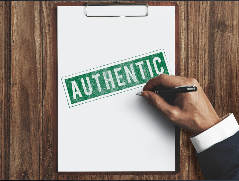 Business hierarchy concept with chessboard, figures on pyramid of wooden blocks on foggy and wooden background side view.